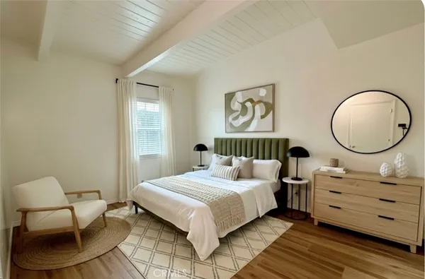 a bedroom with a bed and chair