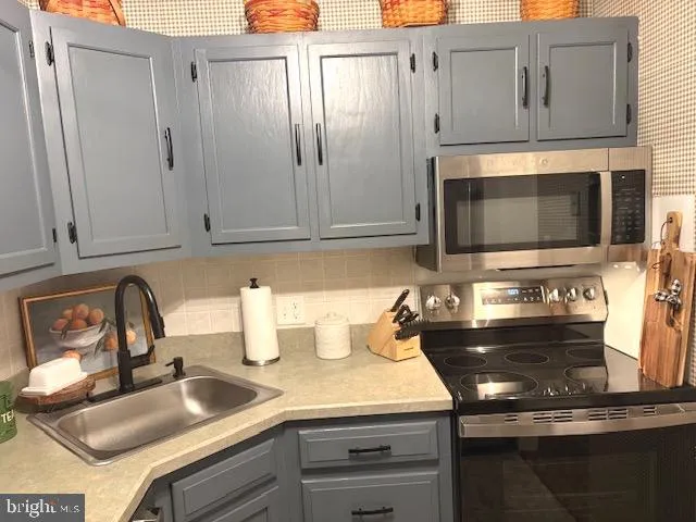 a kitchen with stainless steel appliances granite countertop a sink and cabinets