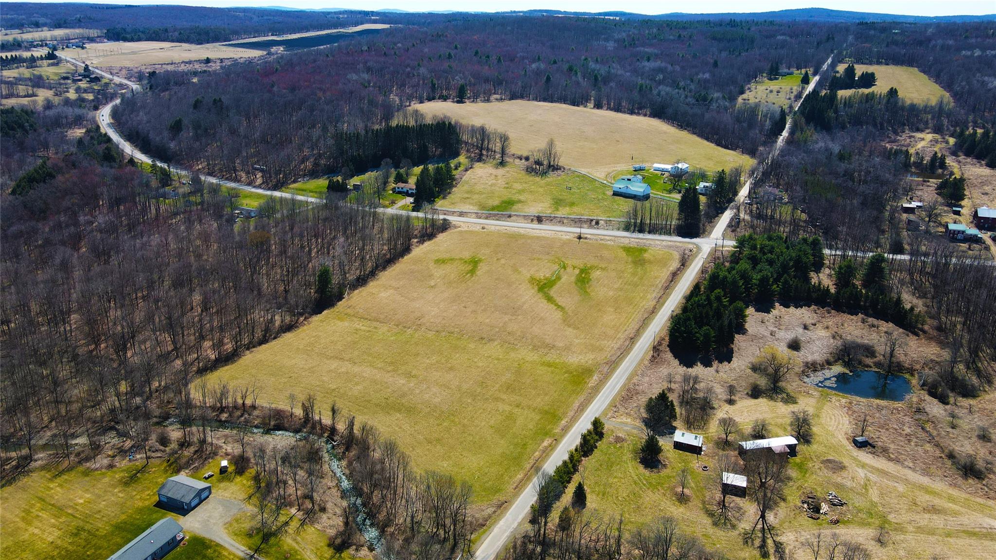892 Bowbell Road Greene, NY 13778 - Photo 2 of 35 Aerial view of property's location with rural landscape and a heavily wooded area