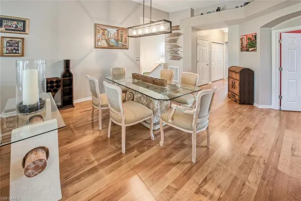 a view of a dining room with furniture and wooden floor