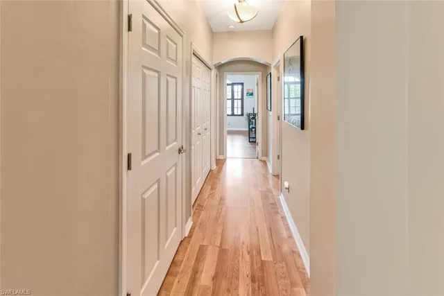 a view of a hallway with wooden floor and staircase