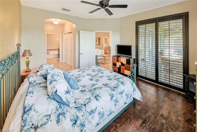 a bedroom with a large bed and a flat tv screen