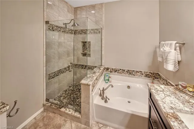 a bathroom with a bathtub and shower