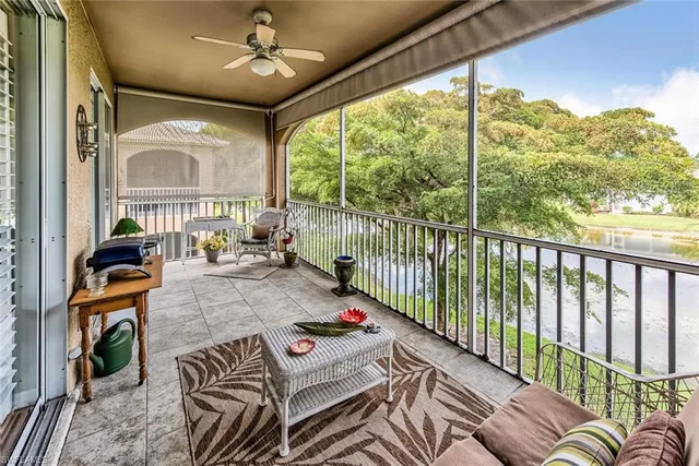 a living room with furniture tv and a large window