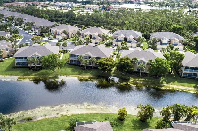 an aerial view of lake residential houses with swimming pool and outdoor space