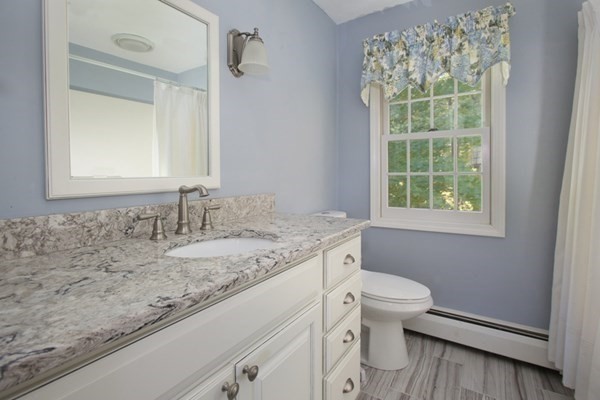 55 Emerson Road Walpole, MA 02032 - Photo 23 of 35 a bathroom with a granite countertop sink toilet and mirror