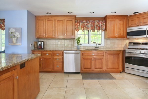 55 Emerson Road Walpole, MA 02032 - Photo 8 of 35 a kitchen with stainless steel appliances granite countertop a stove sink and cabinets
