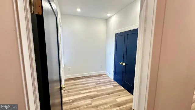 a view of a hallway with wooden floor and entryway