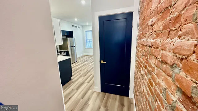 a kitchen with a refrigerator sink and cabinets