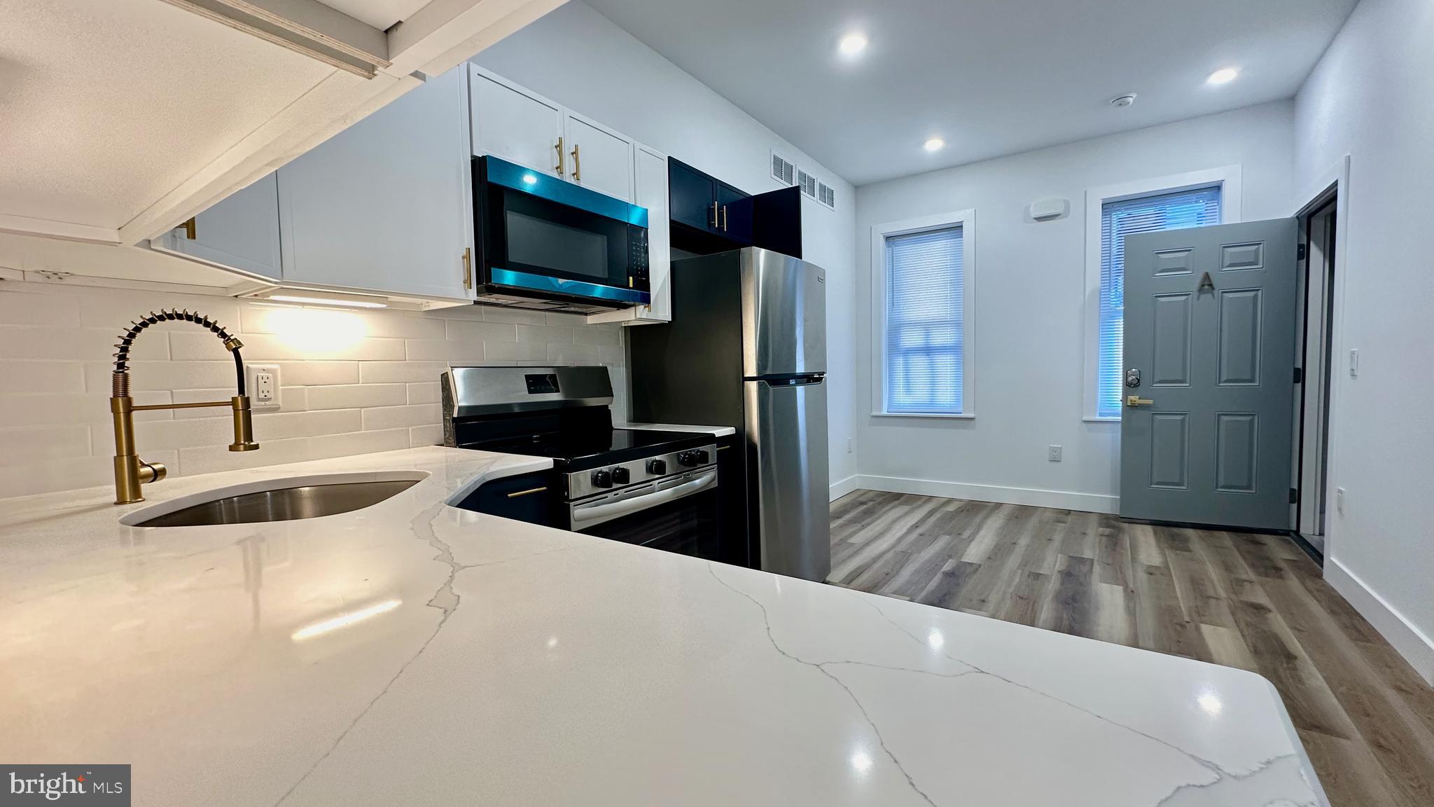 4525 North Gratz Street, Unit A Philadelphia, PA 19140 - Photo 3 of 21 a kitchen with a refrigerator and a sink