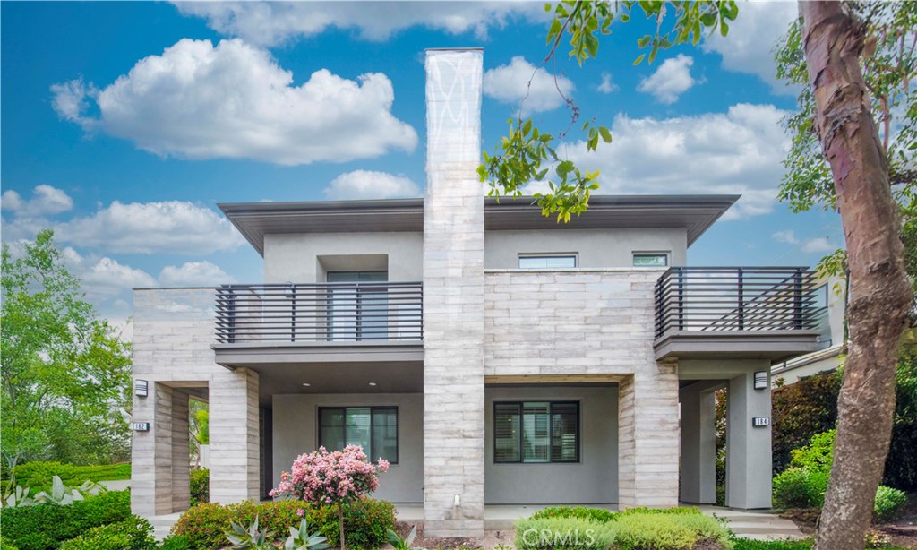 a front view of a house with plants