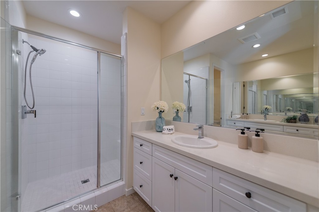 184 Terrapin Irvine, CA 92618 - Photo 27 of 74 a bathroom with a double vanity sink mirror and shower