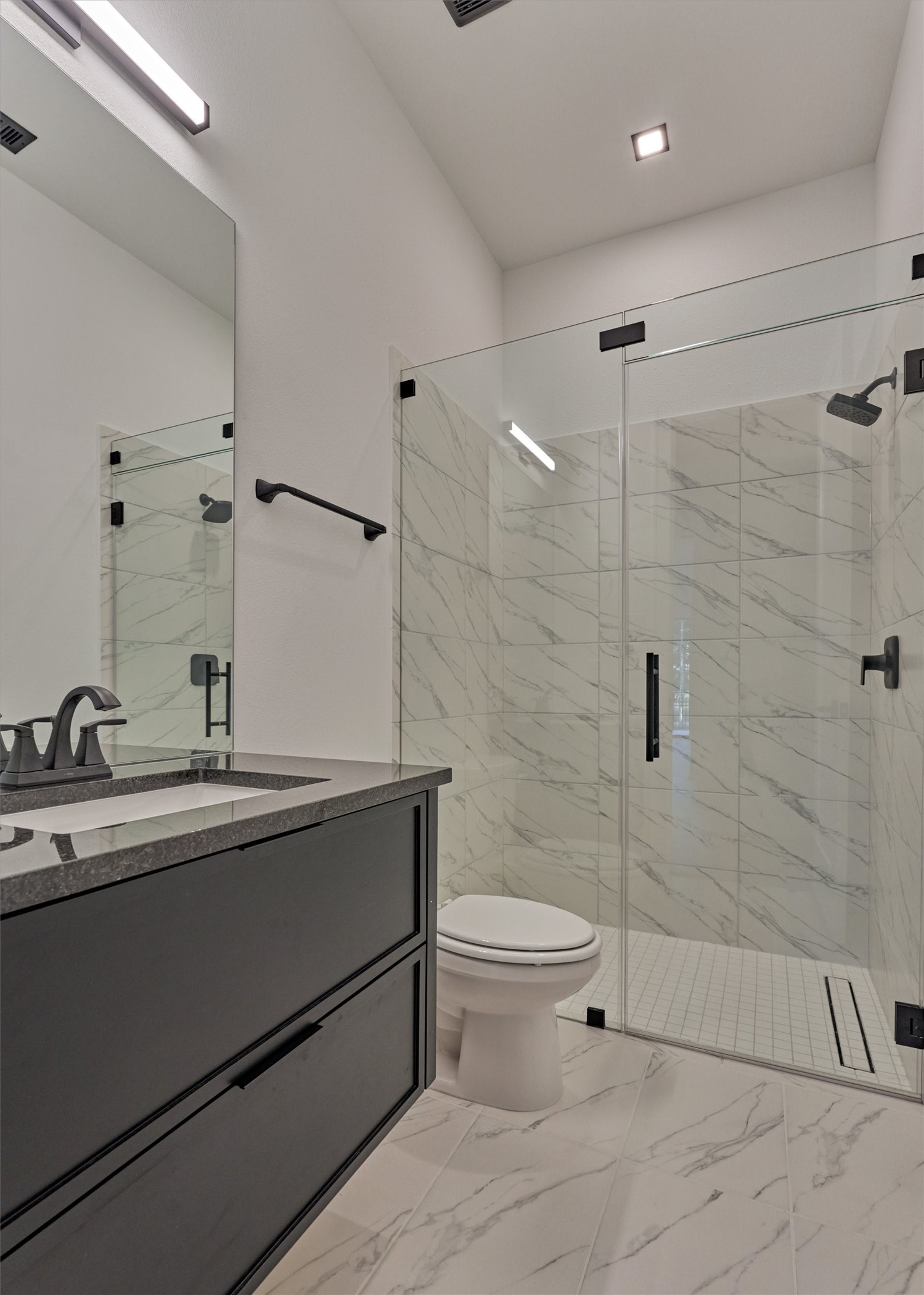 18 Squire Creek Way Spring Spring, TX 77389 - Photo 26 of 50 a bathroom with a sink a toilet and shower