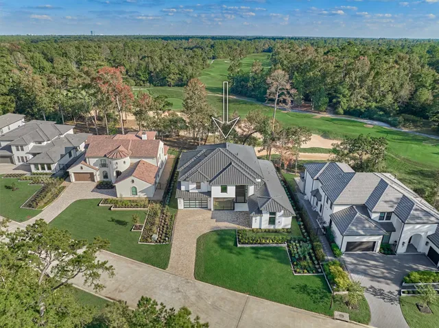 an aerial view of a house with garden space and outdoor seating