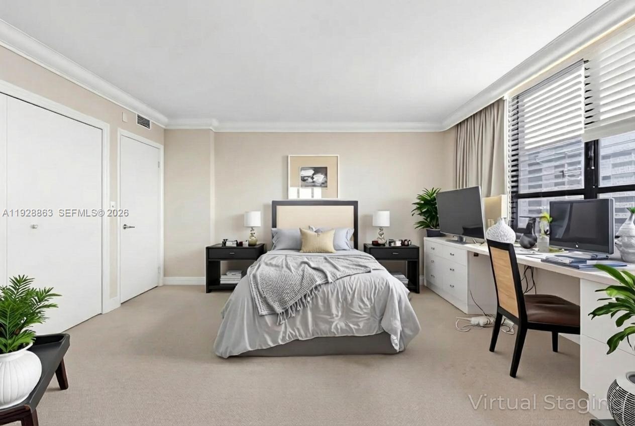 2 Grove Isle Drive, Unit B1110 Miami, FL 33133 - Photo 11 of 29 a bedroom with a bed and a table