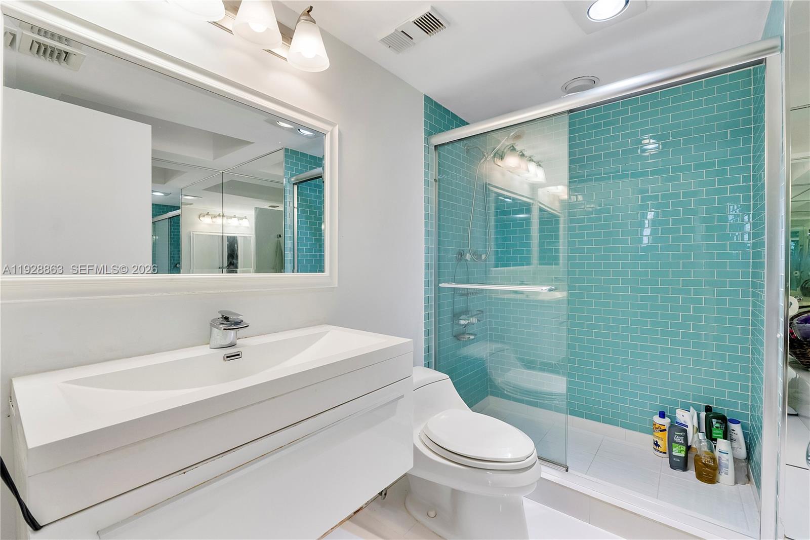 2 Grove Isle Drive, Unit B1110 Miami, FL 33133 - Photo 13 of 29 a bathroom with a sink a toilet and shower