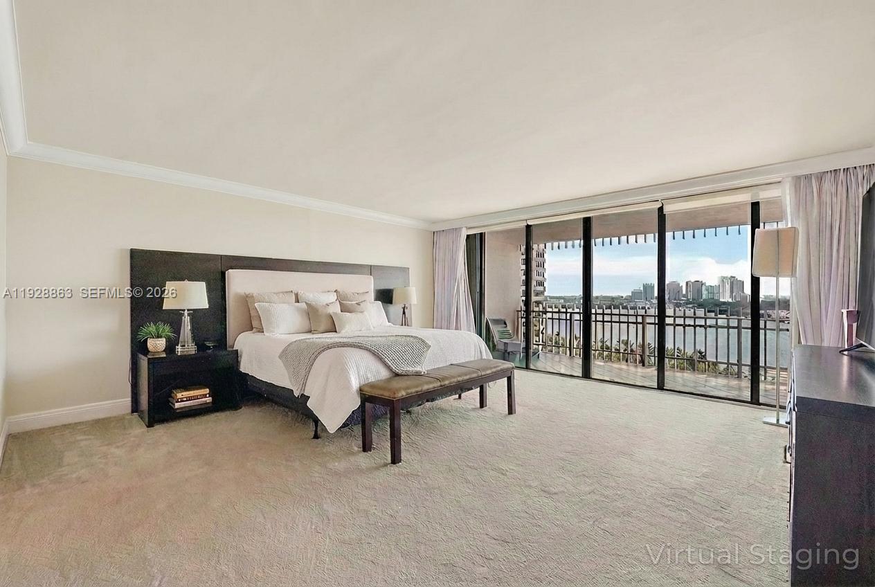 2 Grove Isle Drive, Unit B1110 Miami, FL 33133 - Photo 14 of 29 a bed sitting in a spacious bedroom next to a large window