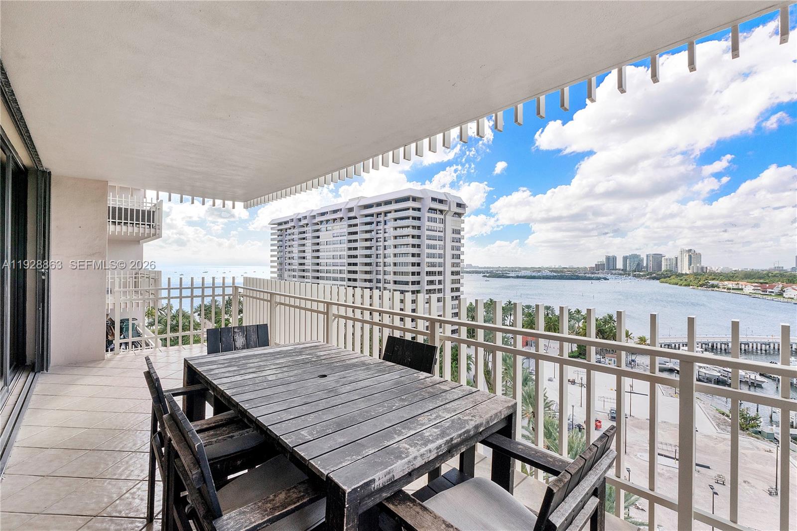 2 Grove Isle Drive, Unit B1110 Miami, FL 33133 - Photo 9 of 29 a roof deck with a table and chairs