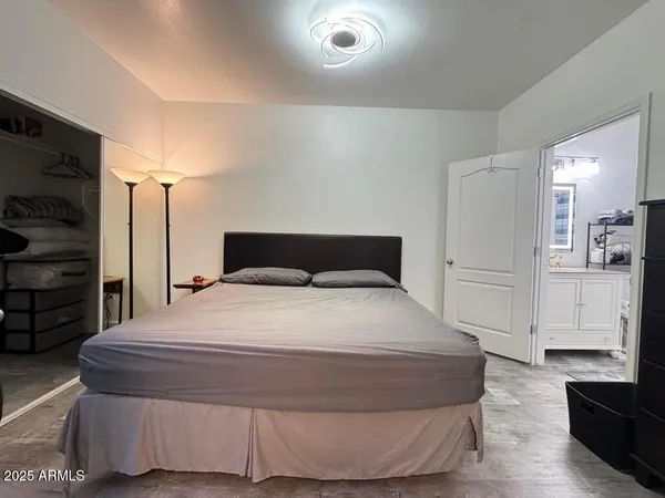a bedroom with a bed and a flat screen tv