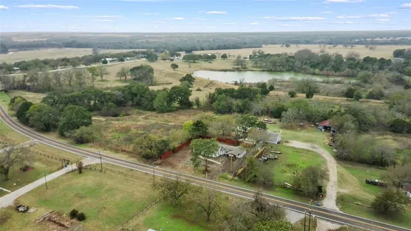 an aerial view of mountain with yard