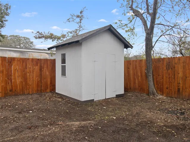 a view of a backyard with a tree