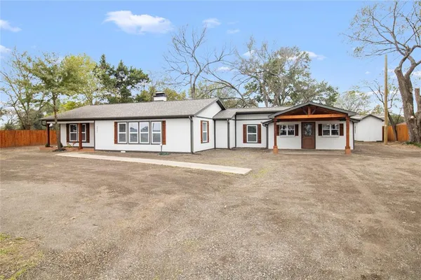 a front view of a house with yard and green space