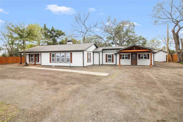 a front view of a house with yard and green space