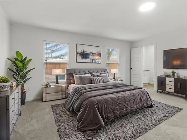 a bedroom with a large bed and a flat screen tv