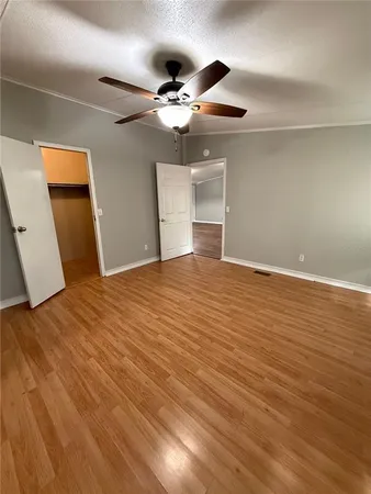 a view of a livingroom with a ceiling fan and wooden floor
