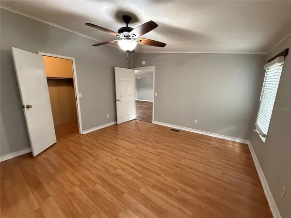 a view of empty room with wooden floor