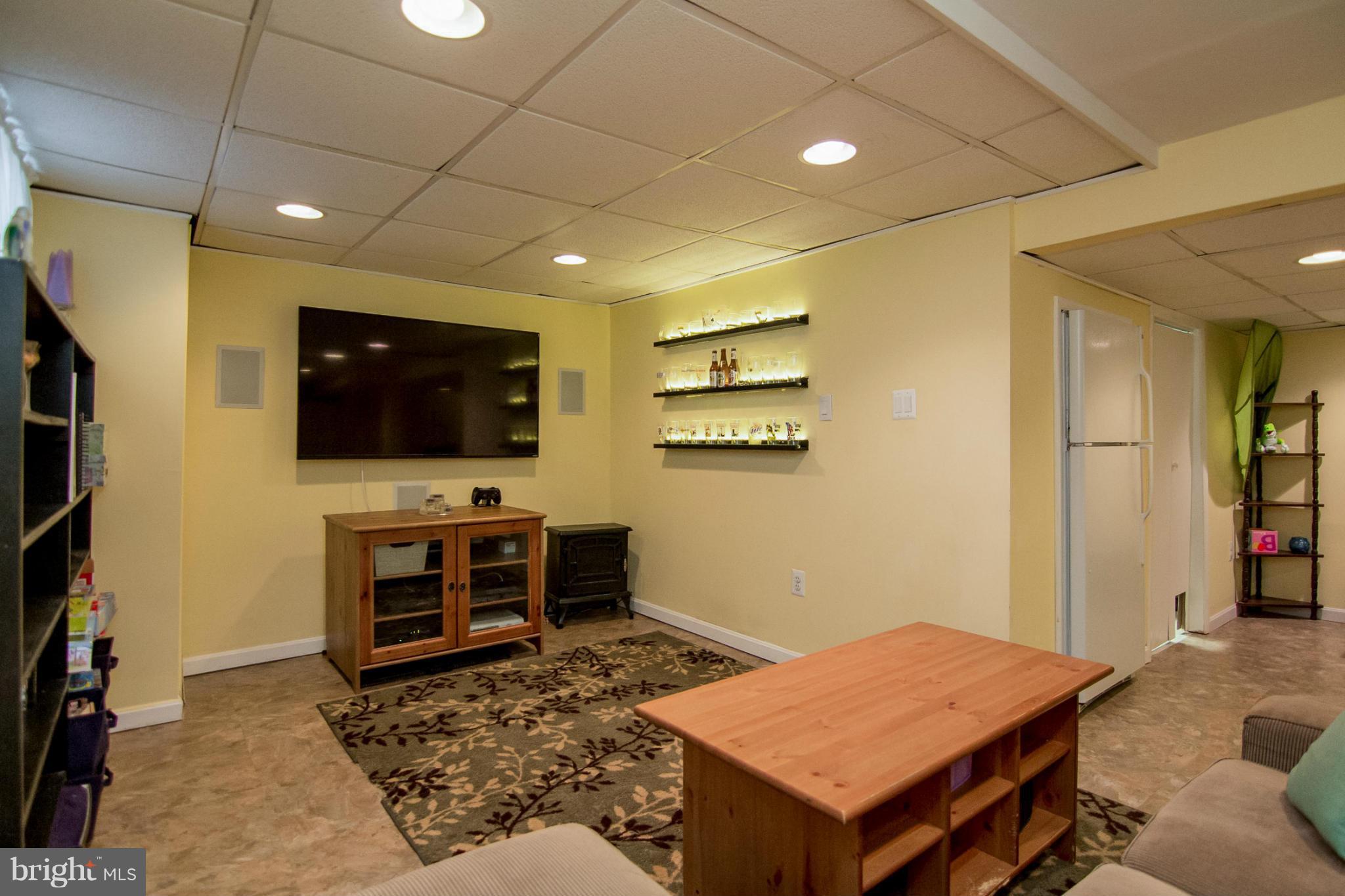 5544 Gayland Road Baltimore, MD 21227 - Photo 19 of 24 a living room with a flat screen tv and kitchen view
