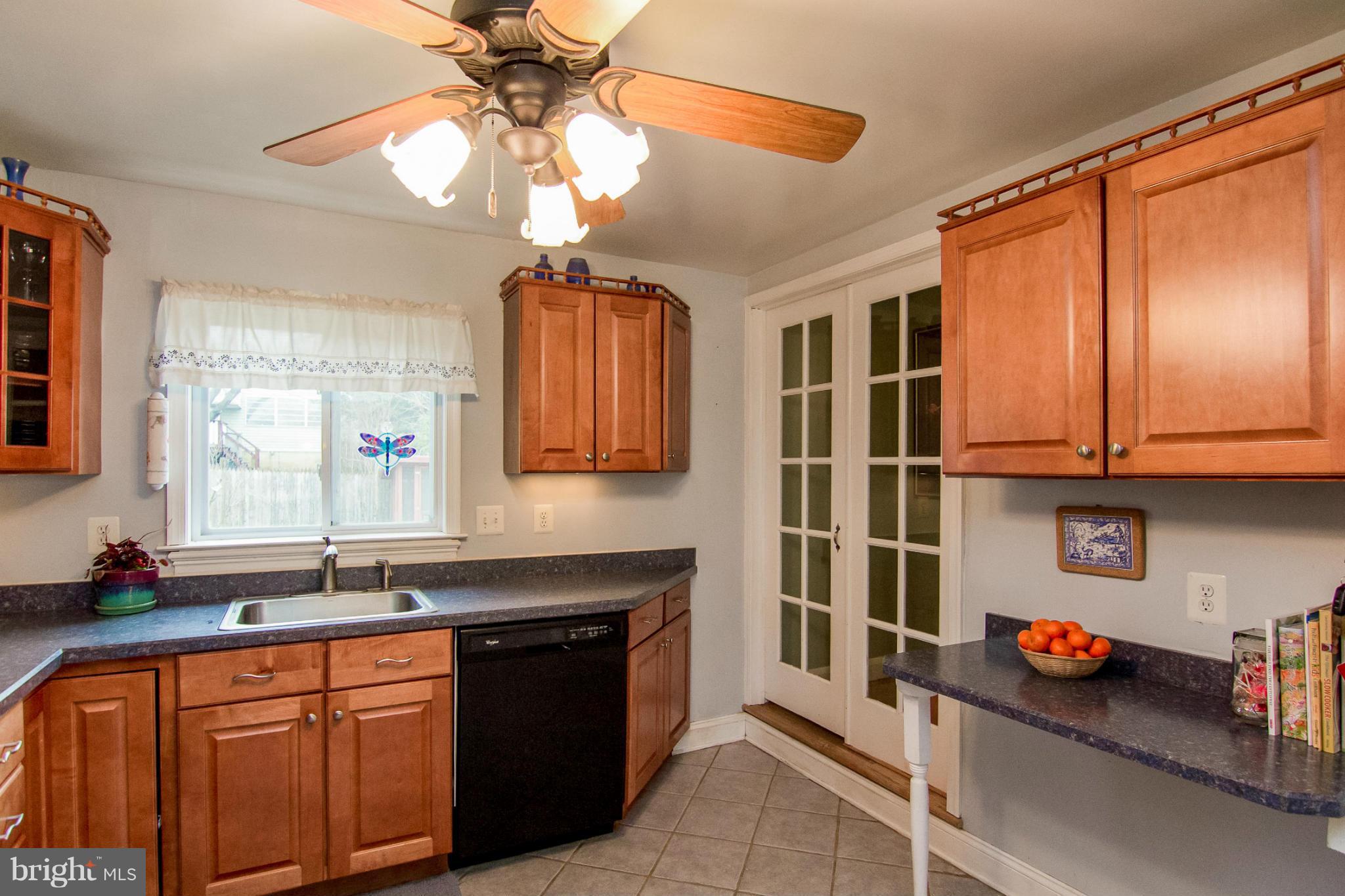 5544 Gayland Road Baltimore, MD 21227 - Photo 5 of 24 a kitchen with stainless steel appliances a sink and cabinets