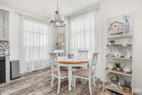 a dining room with wooden floor and a window