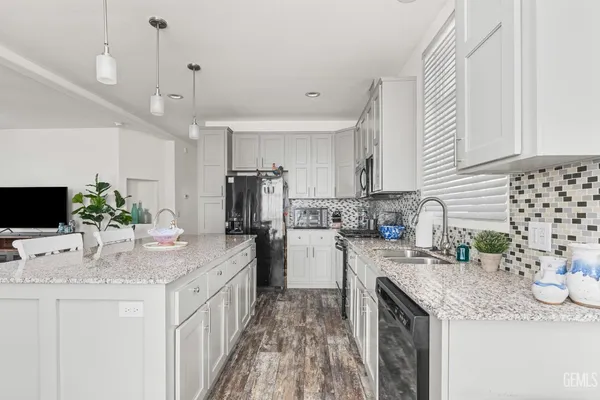 a kitchen with a sink stove and refrigerator