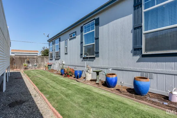 a view of back yard of the house with outdoor seating