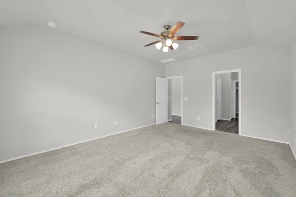 a view of an empty room with a chandelier fan