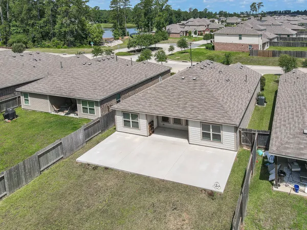 an aerial view of a house with swimming pool garden and patio