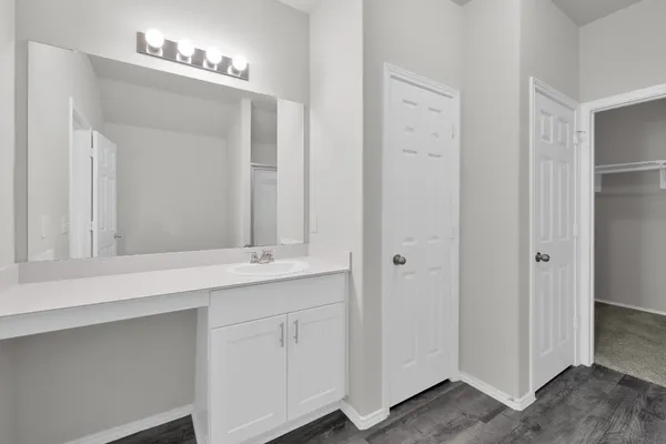 a bathroom with a double vanity sink and a mirror
