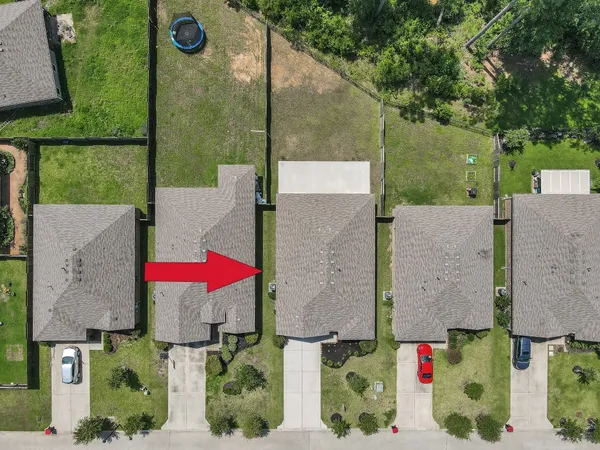 an aerial view of multiple houses with a yard