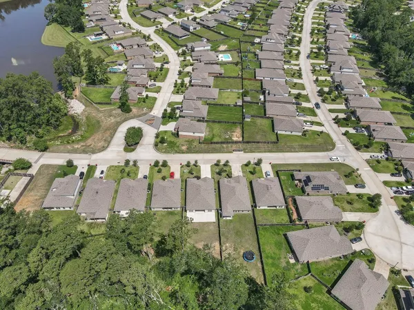 an aerial view of a multi story building with yard