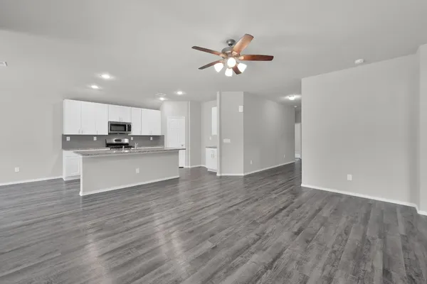 a view of kitchen with cabinets appliances and wooden floor