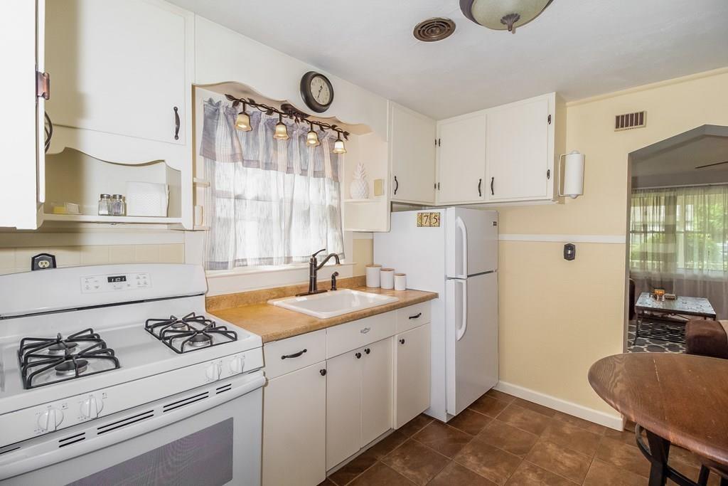 75 Garland Street Springfield, MA 01118 - Photo 11 of 32 a kitchen with a stove a refrigerator and a sink