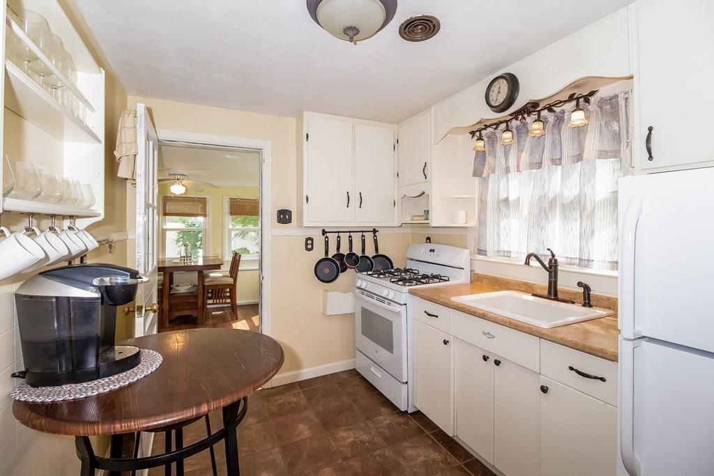 75 Garland Street Springfield, MA 01118 - Photo 12 of 32 a kitchen with a stove a sink and a refrigerator