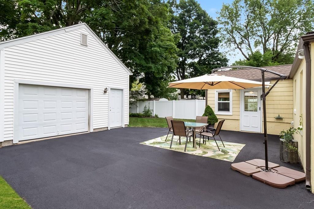 75 Garland Street Springfield, MA 01118 - Photo 4 of 32 a patio with a table and chairs under an umbrella