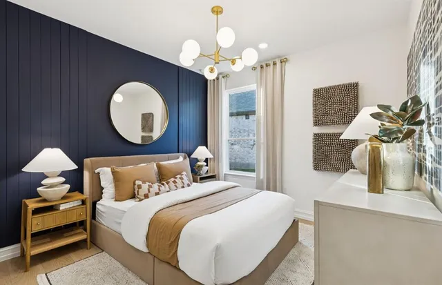 a bedroom with bed and a chandelier