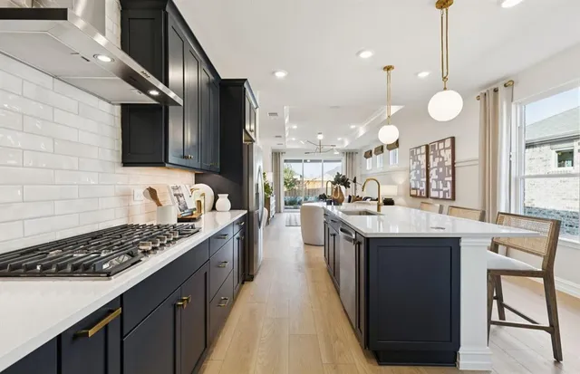 a kitchen with a sink stove top oven and cabinets