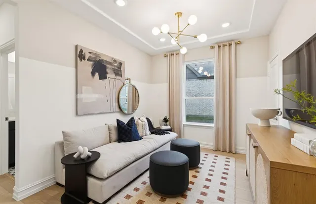 a living room with furniture a chandelier and a flat screen tv