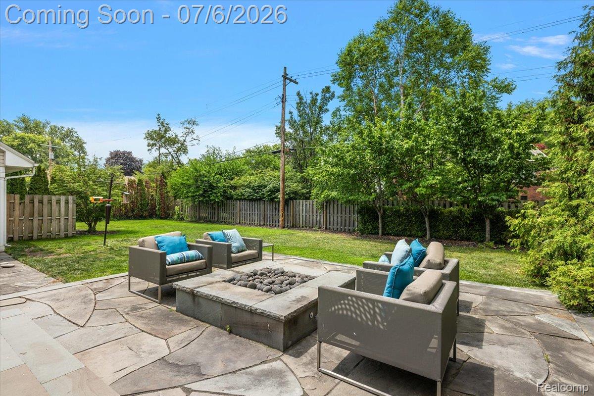 1051 Devonshire Road Grosse Pointe, MI 48230 - Photo 84 of 98 Spacious backyard featuring a flagstone patio, built-in fire pit, and manicured lawn