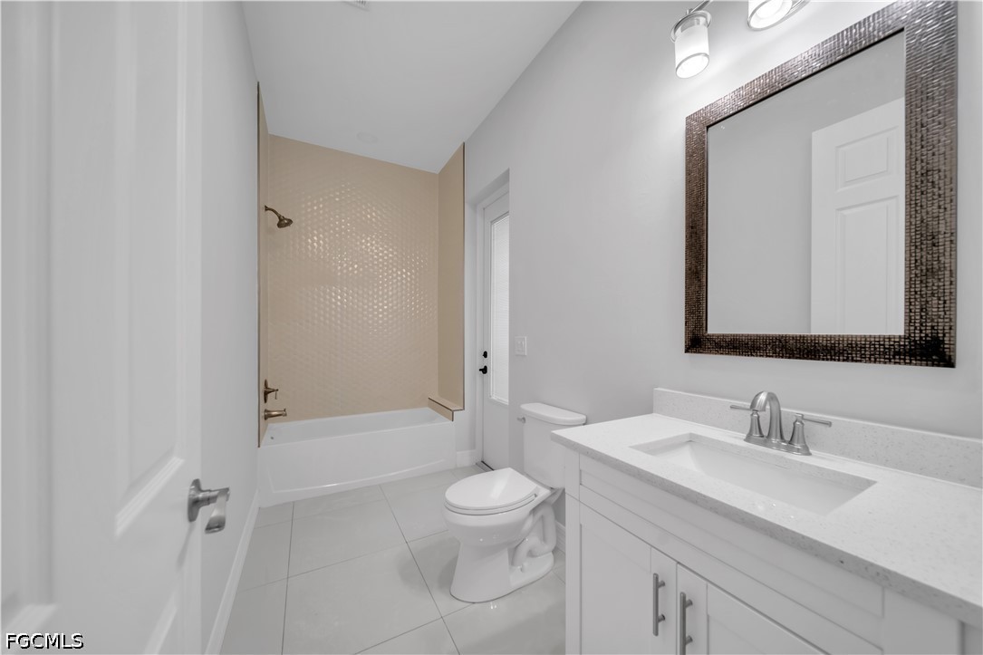 3509 38th Street Southwest Lehigh Acres, FL 33976 - Photo 26 of 47 a bathroom with a granite countertop sink toilet a large mirror and shower