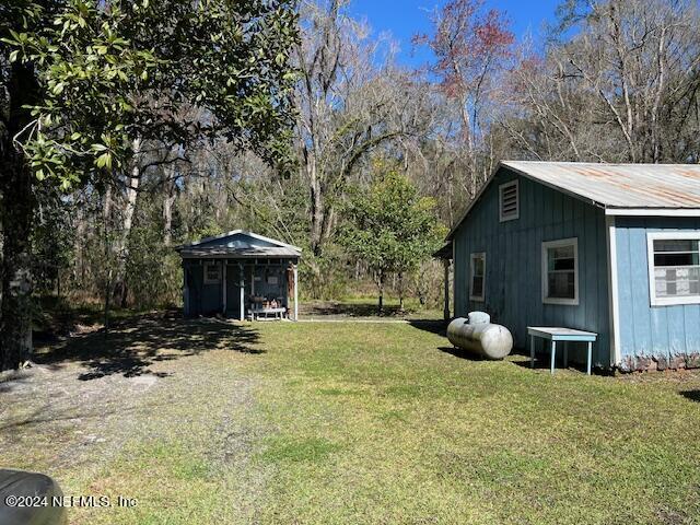 18455 Ware Avenue Jacksonville, FL 32234 - Photo 4 of 8 a front view of a house with a yard and garage